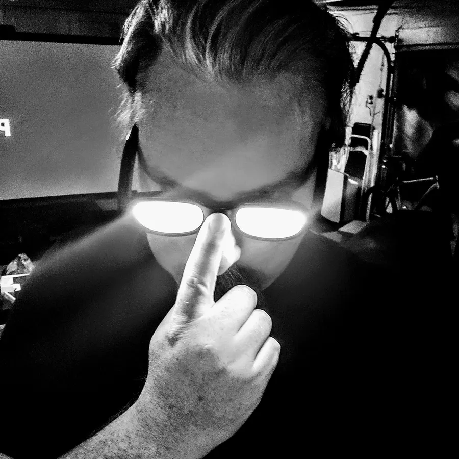Tor with glowing glasses, pushing them up his nose